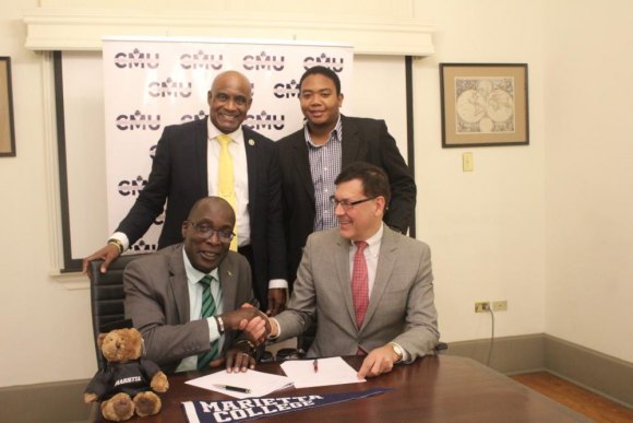 Roosevelt Island's Jim Luce expands philanthropic leadership to Jamaica Jim Luce shakes hands on the deal with Jamaica's Education Minister